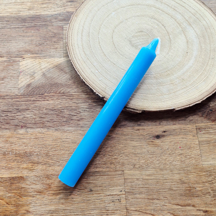 Bougie bleue allumée, symbole de paix, de sérénité et de communication intérieure. Idéale pour les rituels de calme mental, de vérité et d’expression authentique.