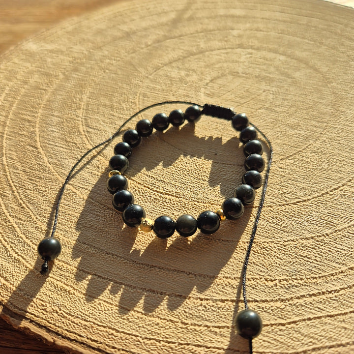 Bracelet réglable en obsidienne œil céleste naturelle 6 mm, monté sur cordon macramé, création artisanale Les Secrets de G&M